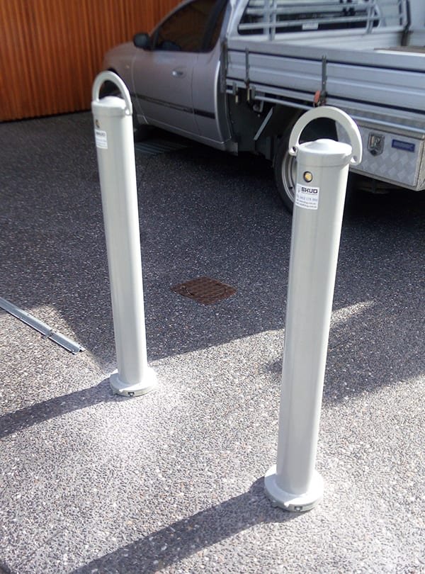 Bolt-down removable bollard installed on a driveway