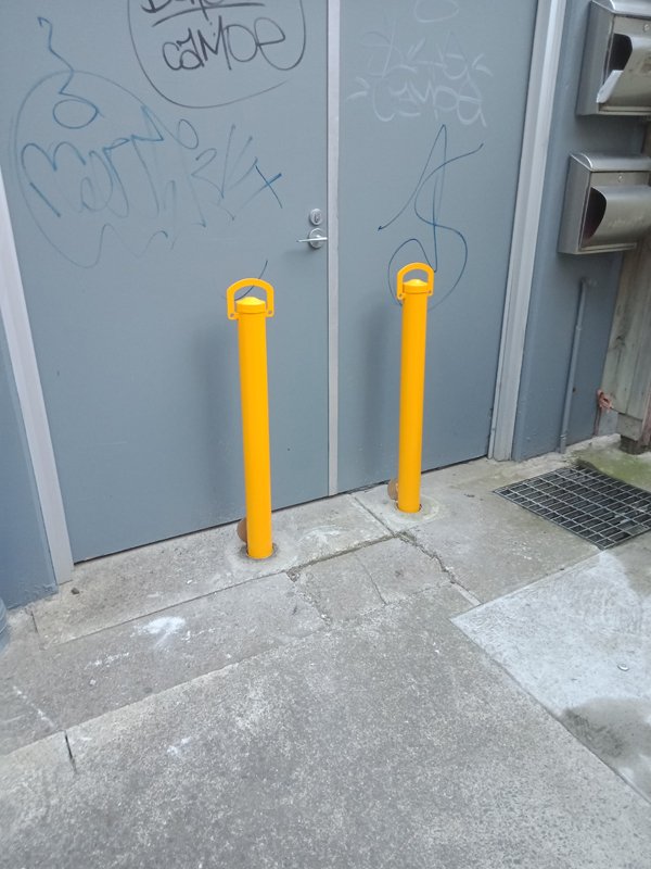 Two removable bollards protecting a rear door at BWS Richmond