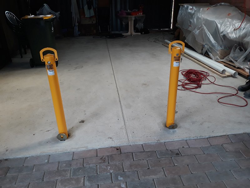 Removable bollards set into the concrete at the front of a garage in Sunshine