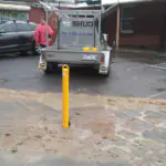Yellow removable bollards protecting a residential parking area in Windsor, Melbourne