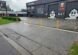 Wide view of Fast Freddies Tyre Service and the yellow bollards across its frontage.