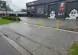 Wide view of Fast Freddies Tyre Service and the yellow bollards across its frontage.