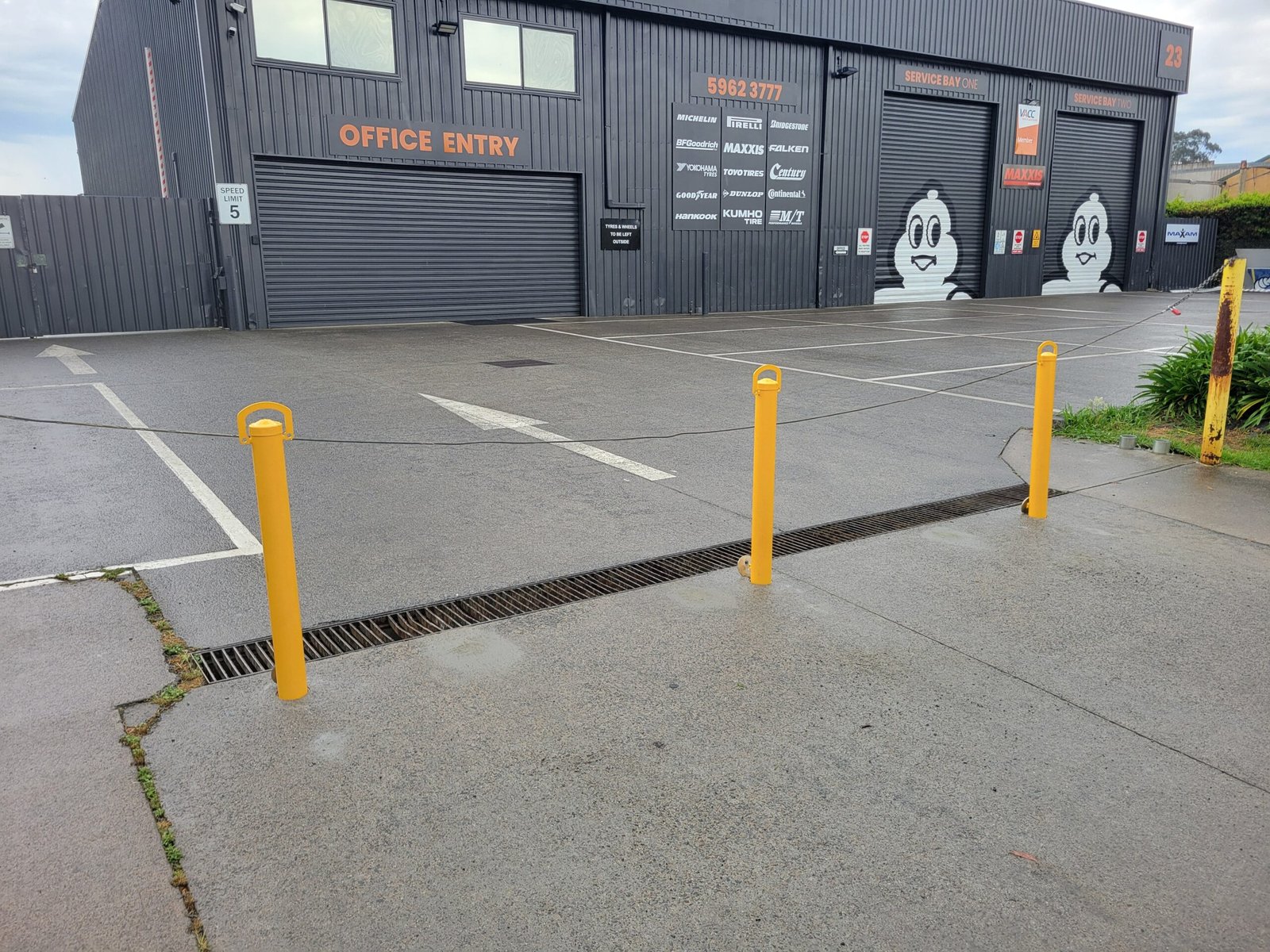 Removable bollards in front of the office entry and service bays at Fast Freddies.