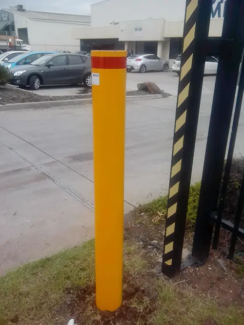 Permanent bollards protecting company gates in Laverton